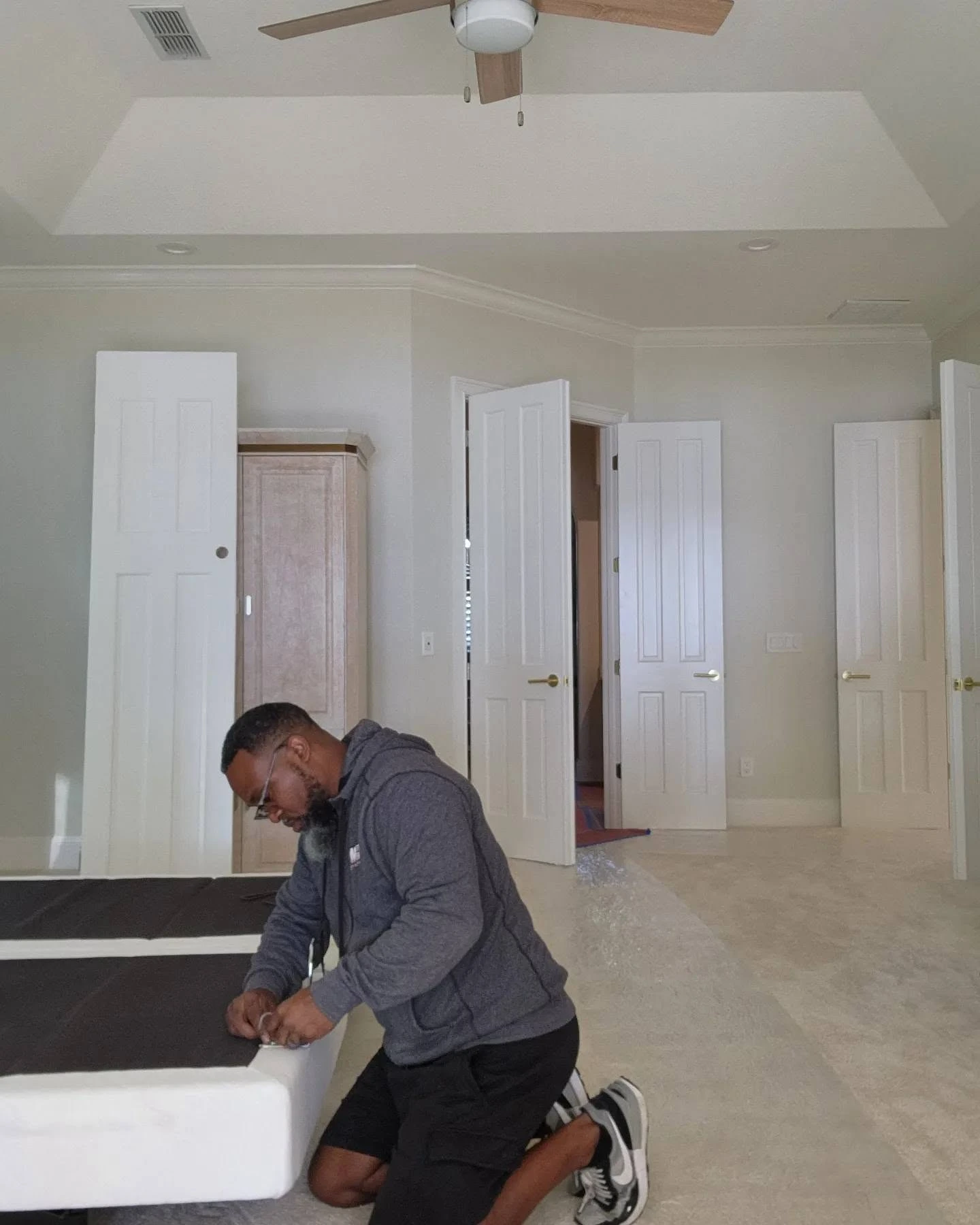Master Movers of Tallahassee crew member reassembling a bed frame in an empty bedroom after a residential move